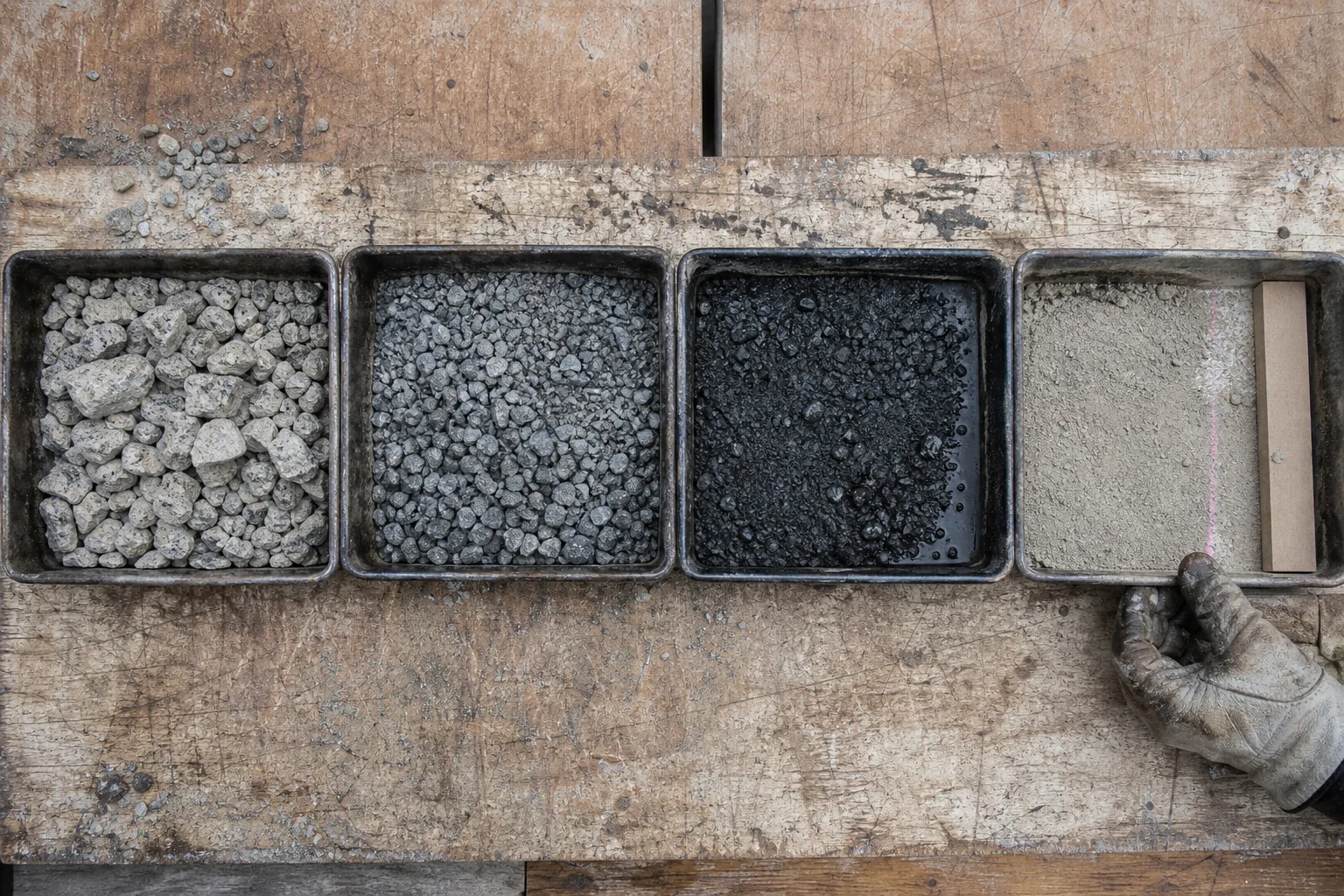 Four separated crushed-ore fractions in sequential sieve pans