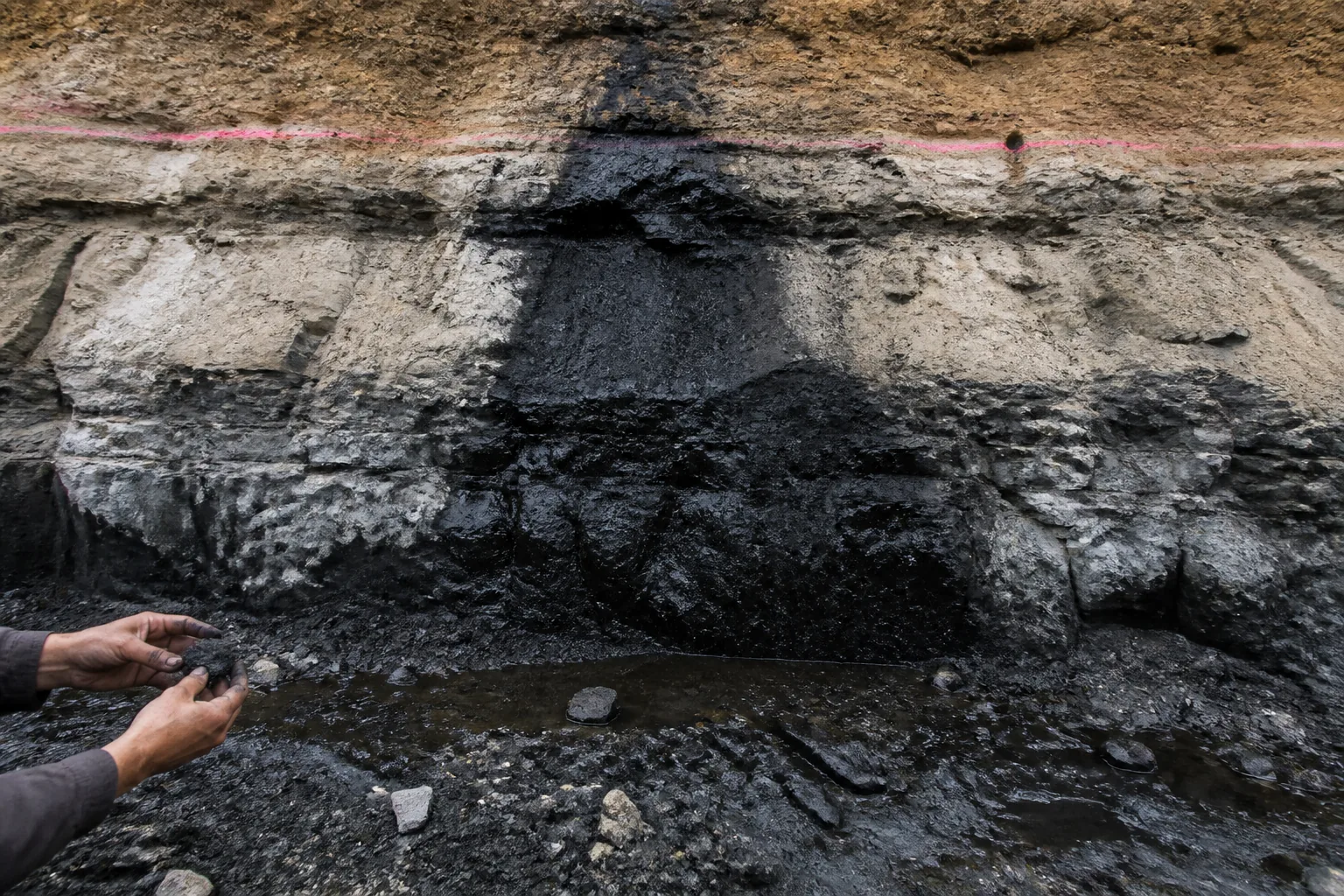 Road-cut seep cascading from iron-stained bed into toe ditch