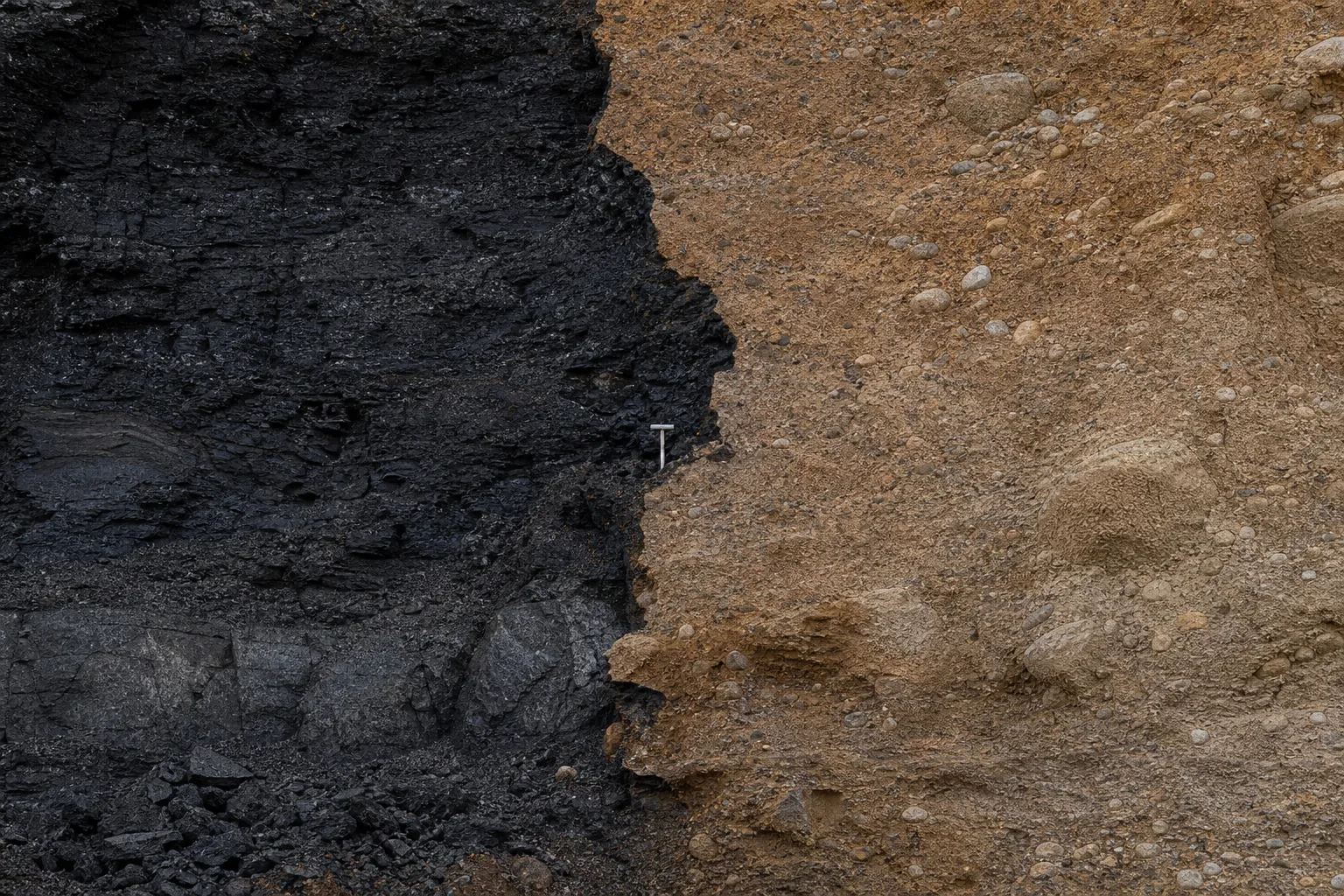 Black peat seam meeting iron-stained compacted till in a river bluff