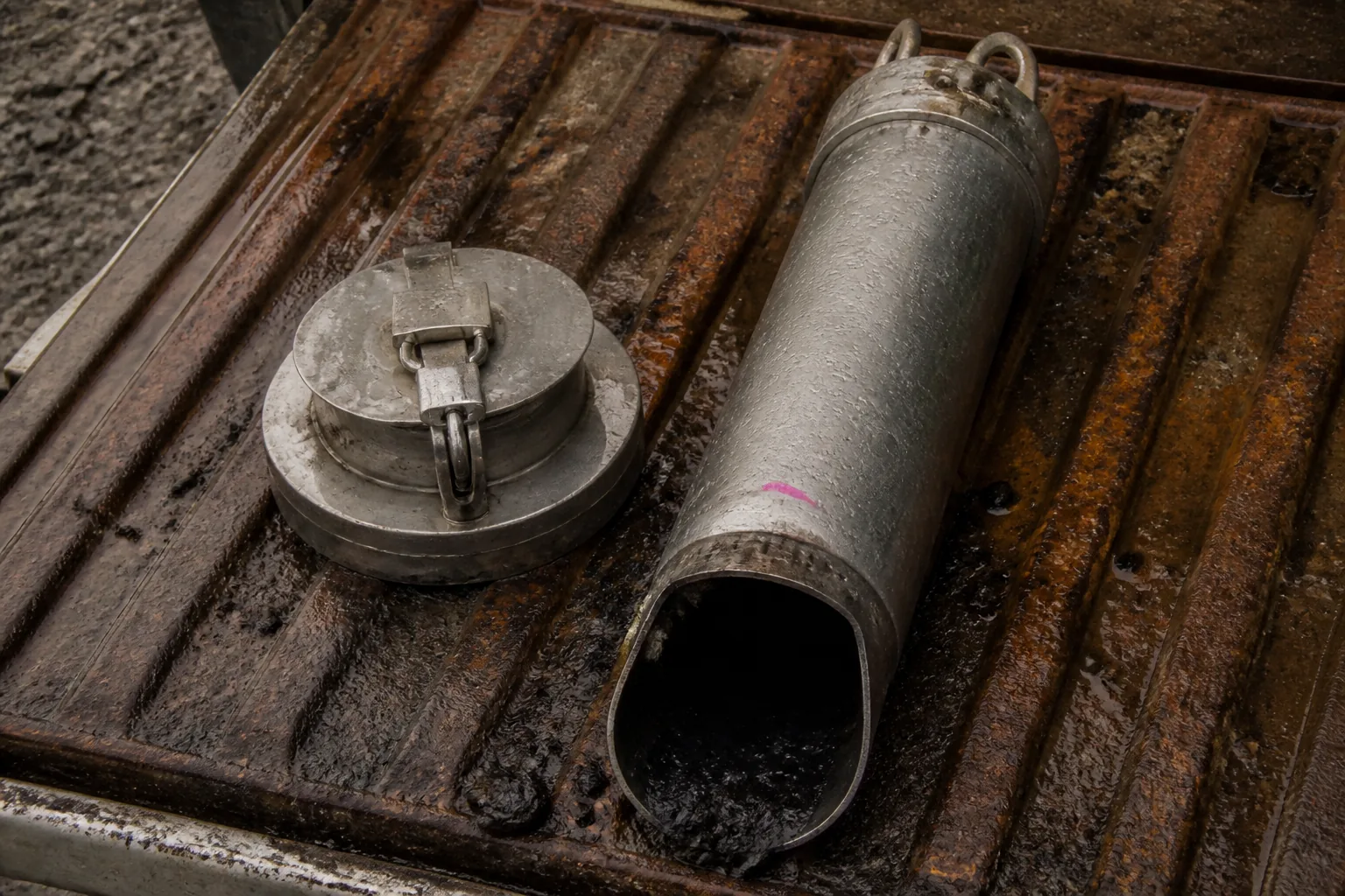 Groundwater bailer beside its lockable well cap