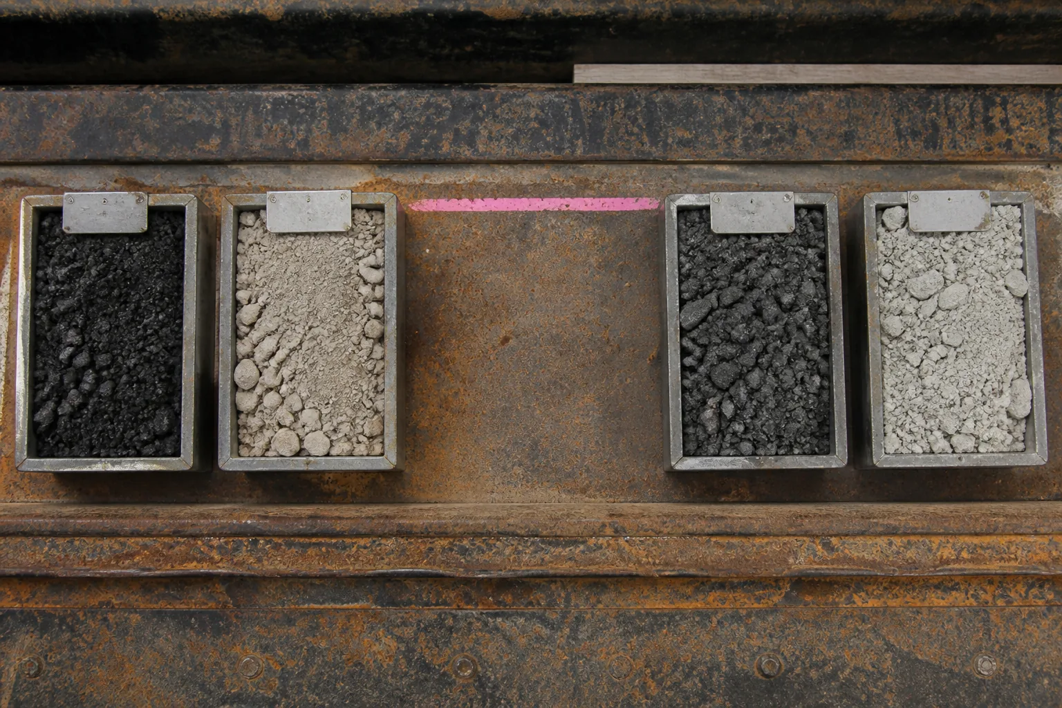 Four slurry containers with one deliberately empty custody position